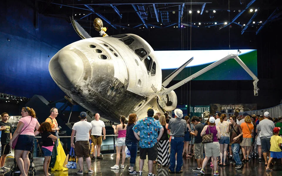 Visitors beneath the displayed Space Shuttle Atlantis