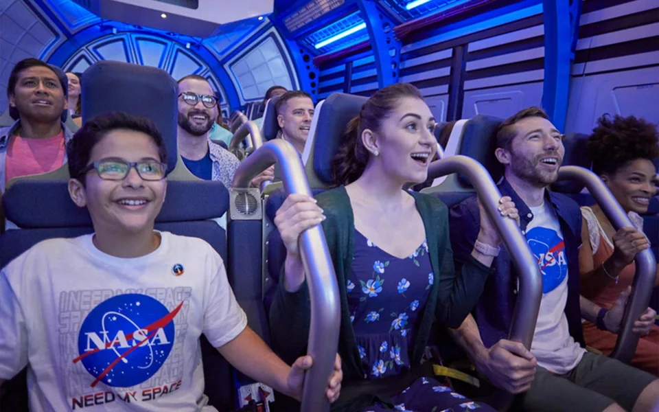 Visitors seated in an indoor space-themed experience