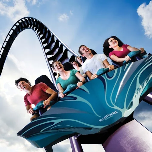 Passengers on a blue SeaWorld roller coaster