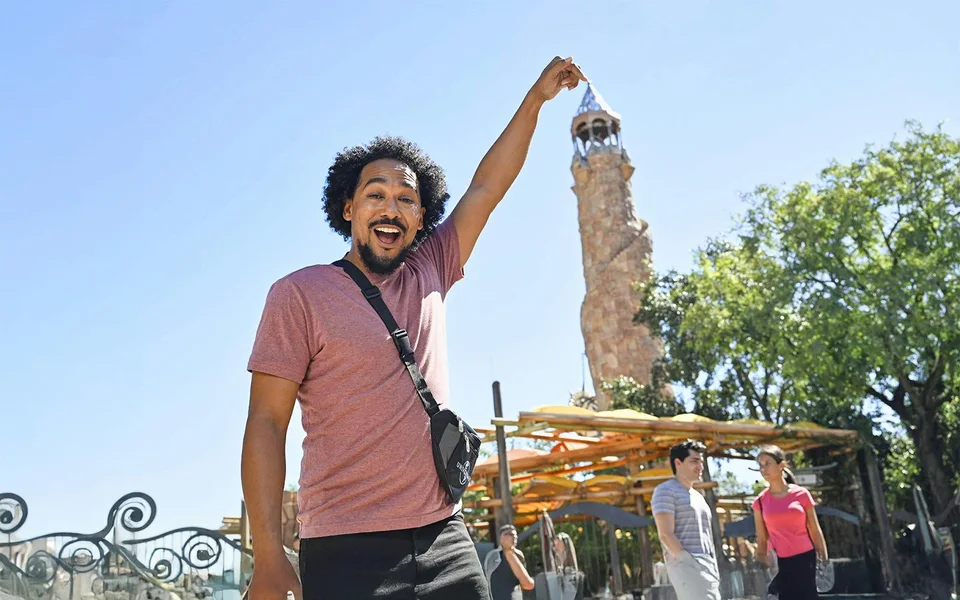 Visitor holding a wand in a themed street at Universal Orlando