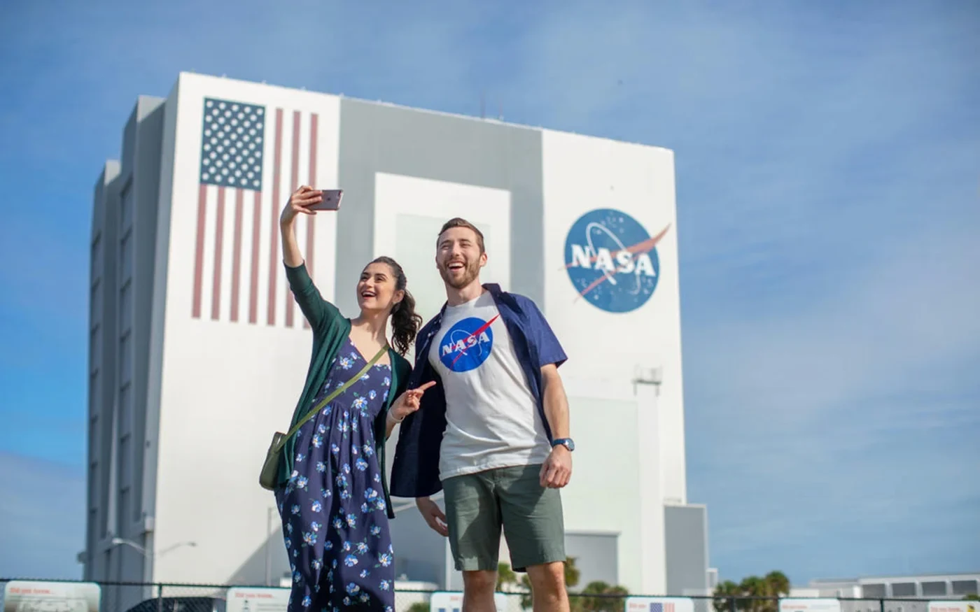 Visitors photographing themselves outside the NASA Vehicle Assembly Building